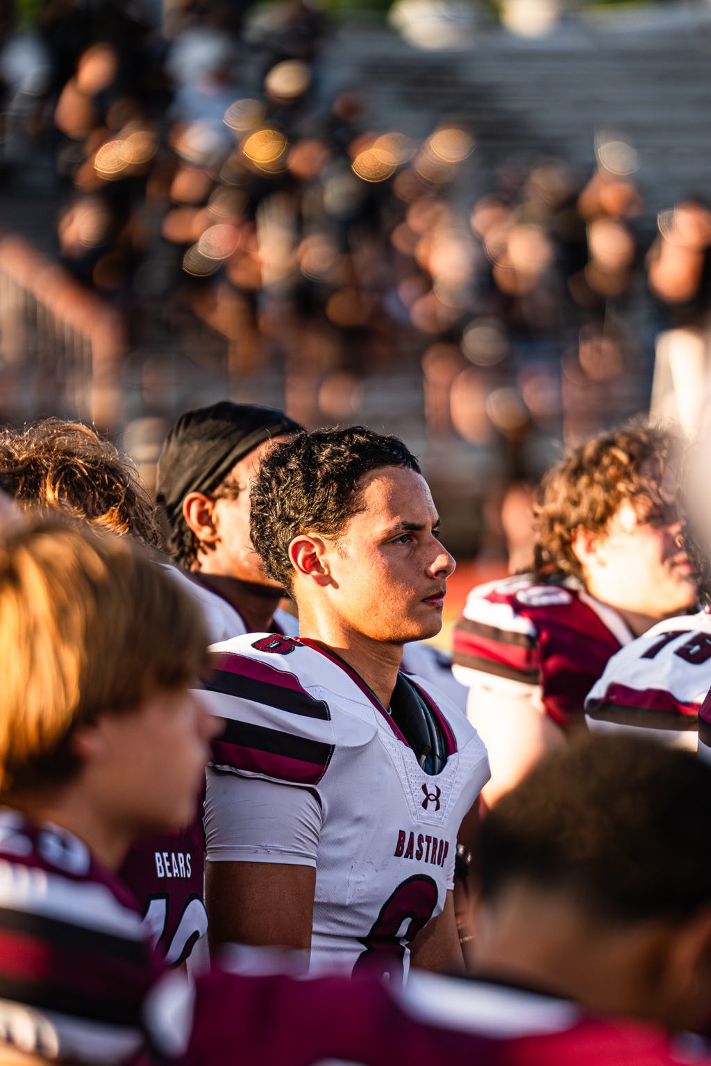 Football player among teammates on the sideline