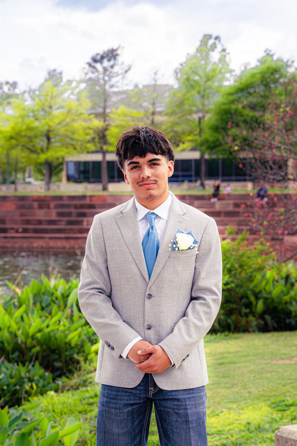 Young man in a gray suit posing outdoors