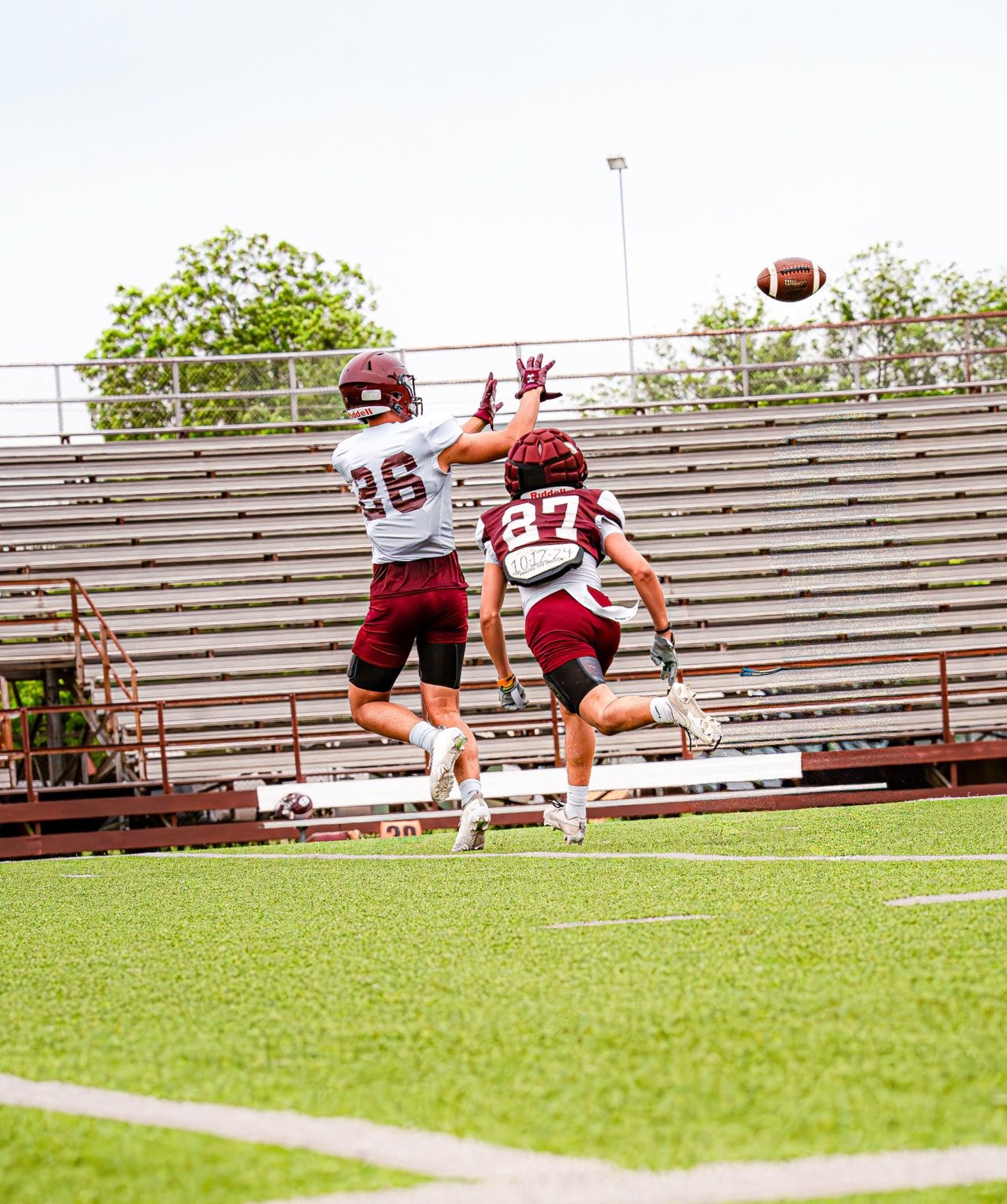 Football players jumping to contest a pass